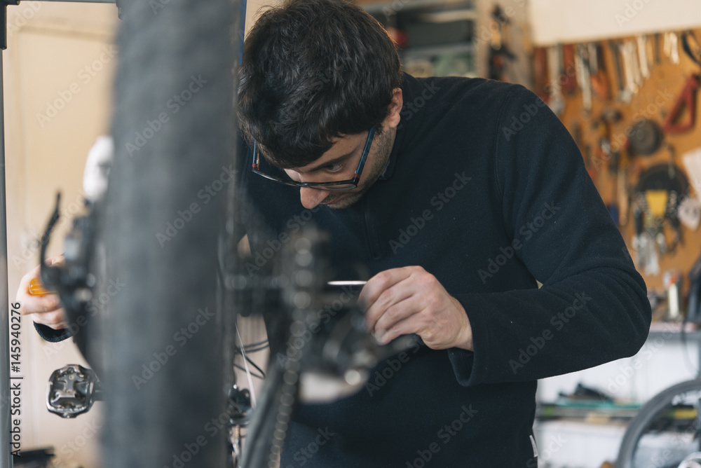 Bicycle mechanic changing rear suspension Bicycle mechanic changing rear suspension