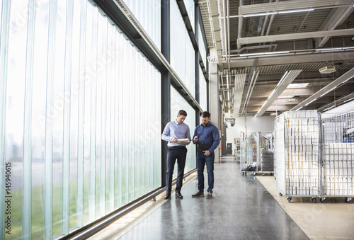 Wallpaper Mural Two men in factory shop floor examining product Torontodigital.ca