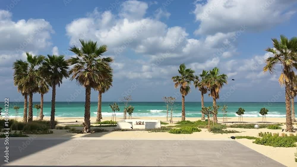 Idyllic tropical sea ocean beach with sand shore HD. Wind blows palm trees. Summer vacation resort Idyllic tropical sea ocean beach with sand shore HD. Wind blows palm trees. Summer vacation resort