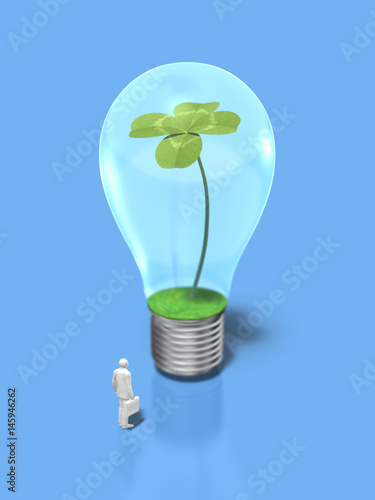 Business figure looking at the light bulb with four-leaf clovers