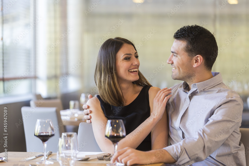 happy young couple in a restaurant