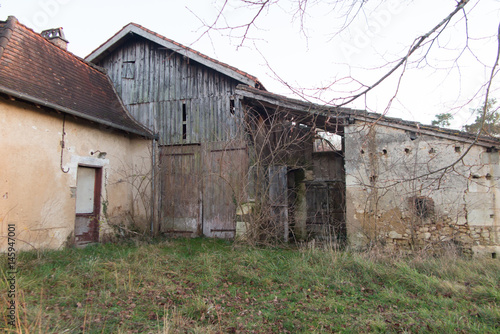 In the French countryside a house with a barn a little abandoned and rusty
