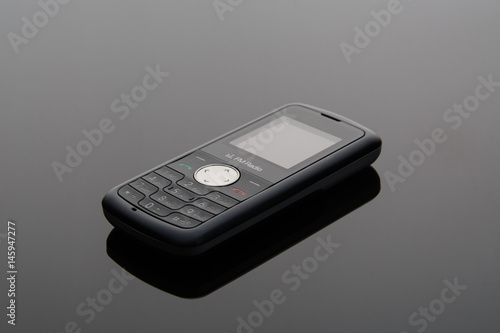 The old mobile phone on a grey background.