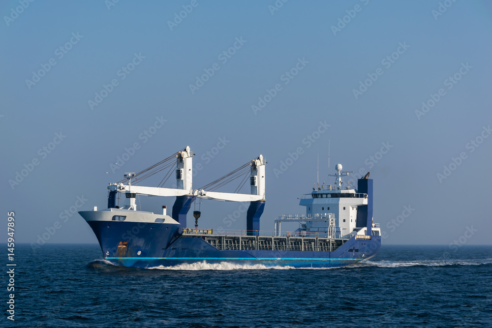 Multipurpose cargo vessel at sea.