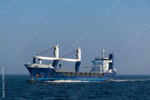 Multipurpose cargo vessel at sea.