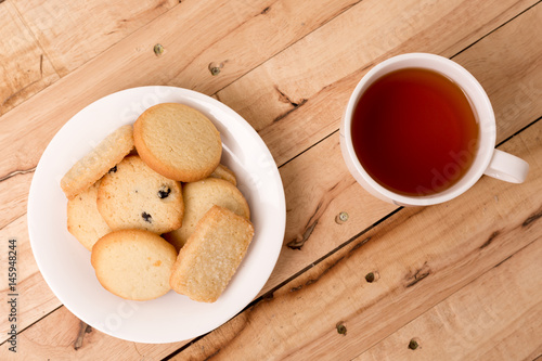 butter cookies with tea on wooden background.