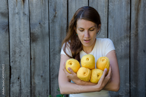 Girl holding yarn balls. Concept knitting crochet hobby craft.