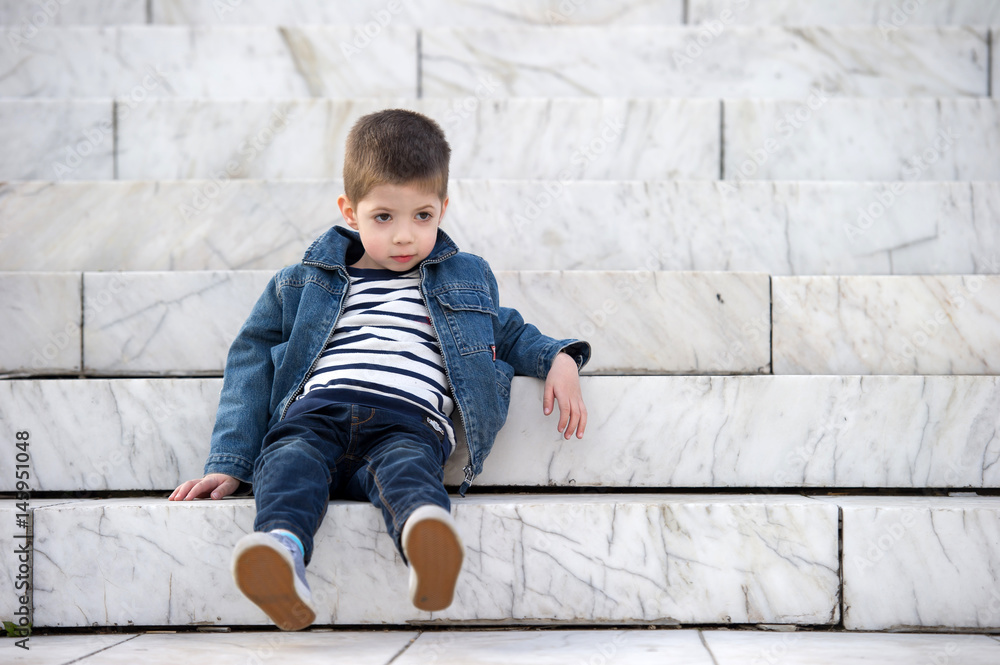 little boy lying on stairs outdoor little boy lying on stairs outdoor