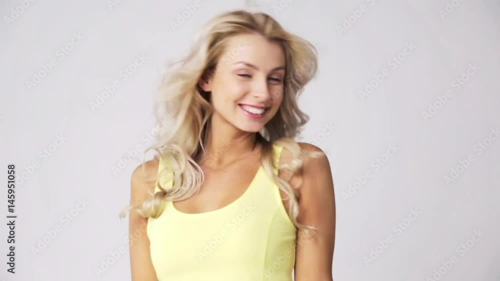 happy smiling beautiful young woman touching hair happy smiling beautiful young woman touching hair