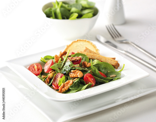 A special salad with spinach, seitan, cherry tomatoes and walnuts.