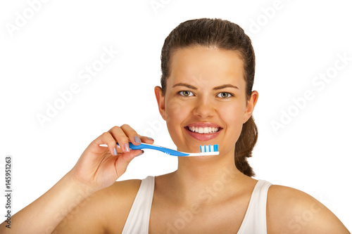 Young woman with toothbrush isolated over white background.