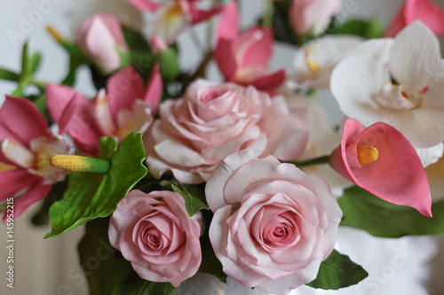 Flowers made from pastry mastic, cake with decorative white