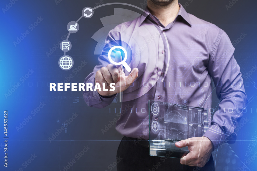 Business, Technology, Internet and network concept. Young businessman working on a virtual screen of the future and sees the inscription: Referrals Business, Technology, Internet and network concept. Young businessman working on a virtual screen of the future and sees the inscription: Referrals
