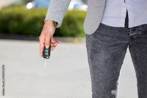 Man hand hold the remote control car alarm systems key