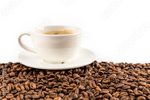 cup of espresso coffee with coffee beans isolated on white with copy space
