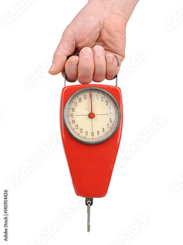 Hand holding a spring scale isolated on white