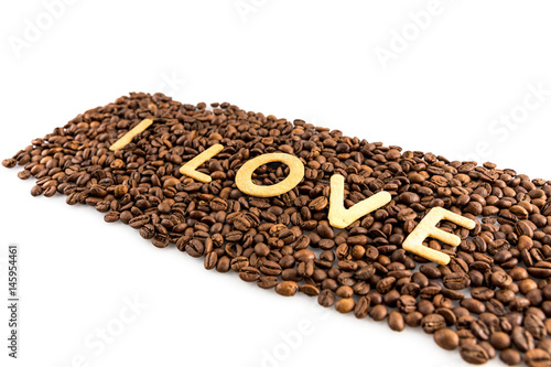 coffee beans with cookies in shape of Love word isolated on white