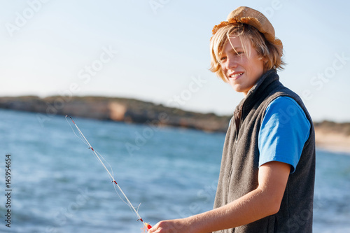 Teenage boy fishing at sea