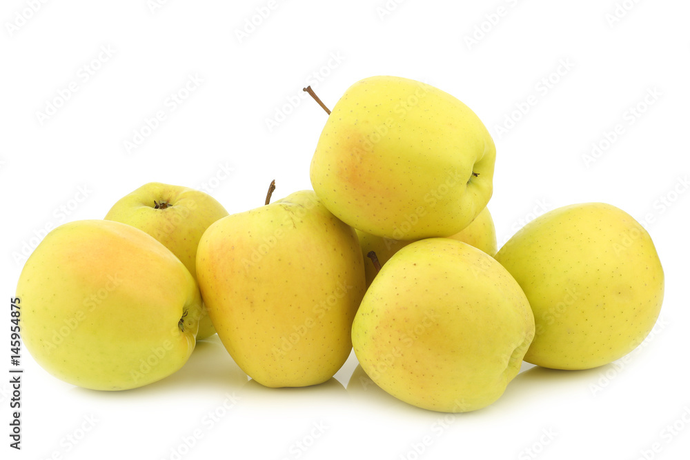 bunch of fresh yellow apples on a white background