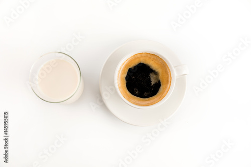 Top view of cup of fresh hot coffee with milk isolated on white