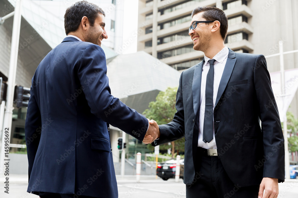 Two businessmen shaking their hands Two businessmen shaking their hands