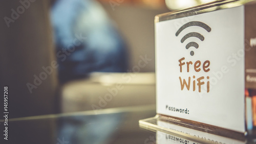 Free Wifi Signal Sign On Coffee Table. photo