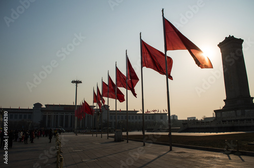 Chinese Flags Swaying in the Morning Breeze with Sunshine at Tiananmen Square, Beijing, China