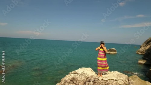 Young Woman In Virtual Headset or 3D Glasses On Beach By Sea. Aerial. photo