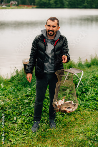 angler on a river with a catch spring photo