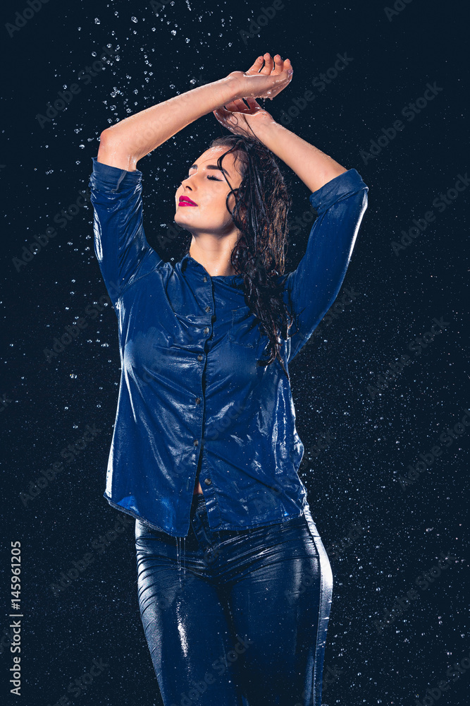 Young beautiful woman under splash of rain Young beautiful woman under splash of rain