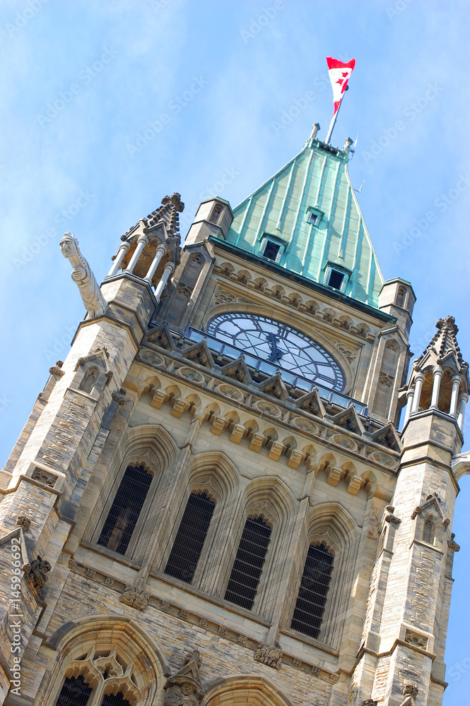 Peace Tower (officially: the Tower of Victory and Peace) with blue sky background in downtown Ottawa, Ontario, Canada