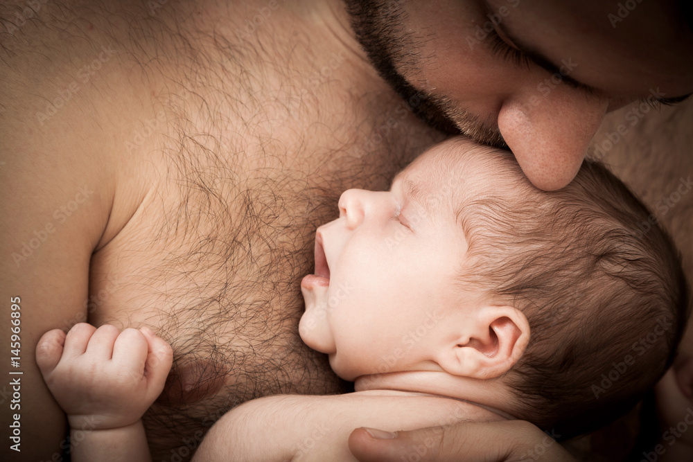 newborn child and father