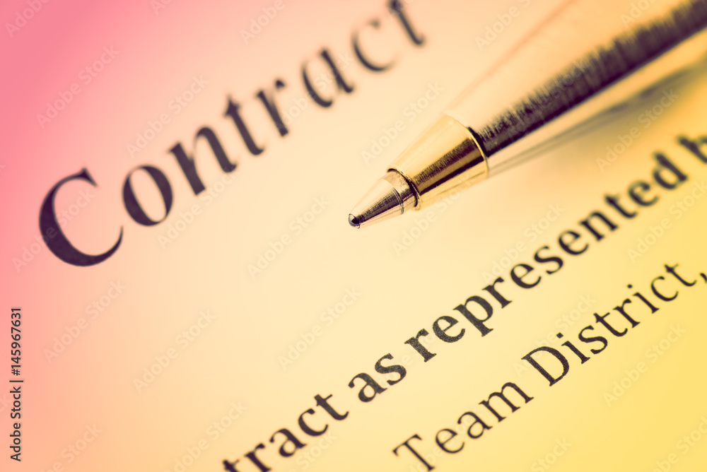 Colorful gradient style : Blue ballpoint pen on a contract. A contract is a voluntary arrangement between two or more parties that is enforceable by law as a binding legal agreement.