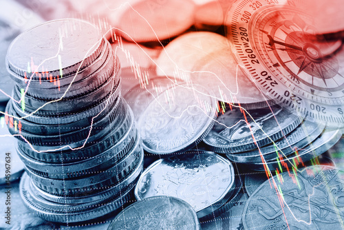 Pile and a stack of coins with technical chart of financial instruments. A concept about currency trading or investing which investors must analyse and make the right decision for optimal profits. photo