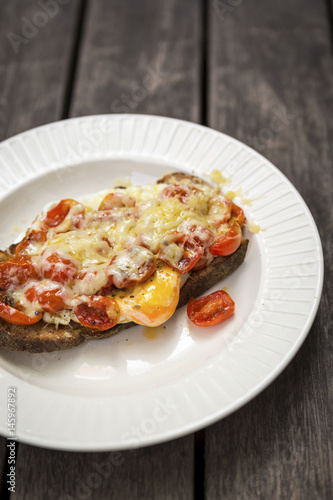 Healthy breakfast, cherry tomato with egg and cheese on toast 