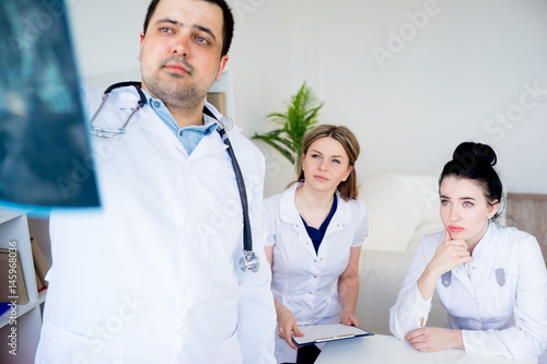 Group of doctors looking at xray