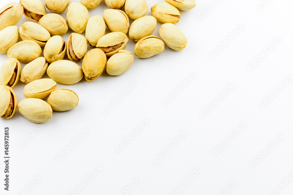 Isolated roasted pistachios nuts on a white background Isolated roasted pistachios nuts on a white background