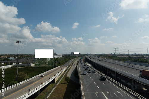 bird eye view of highway beside habitat with skyline and blue sky cloud. light and shadow from nature light in day.