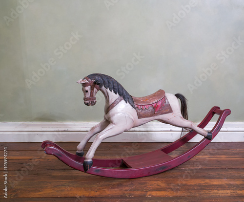 Vintage rocking horse on wooden floor. Salacgriva, Latvia. photo