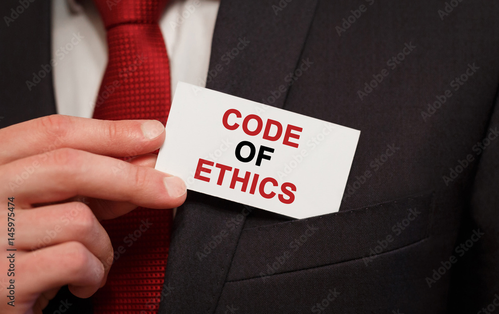 Businessman putting a card with text Code of Ethics in the pocket Businessman putting a card with text Code of Ethics in the pocket