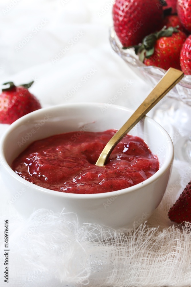 Homemade Strawberry Sauce served in a bowl, selective focus Homemade Strawberry Sauce served in a bowl, selective focus