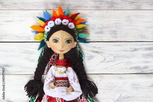 Textile handmade doll of Ukrainian cute women in national costume and wreath