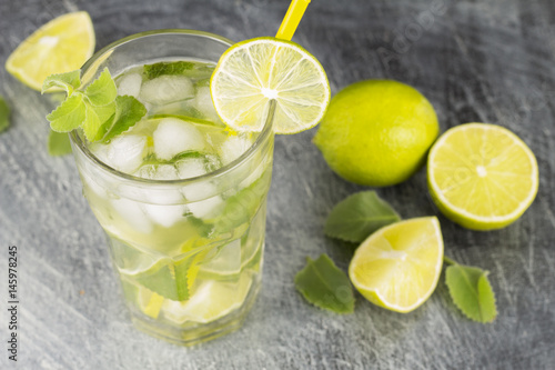 Mojito cocktail with lime and mint on a black background