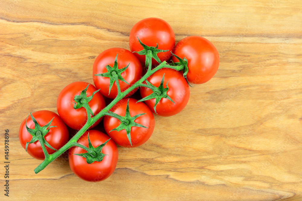 Tomaten - Rispentomaten am Holzbrett mit Textfreiraum Tomaten - Rispentomaten am Holzbrett mit Textfreiraum