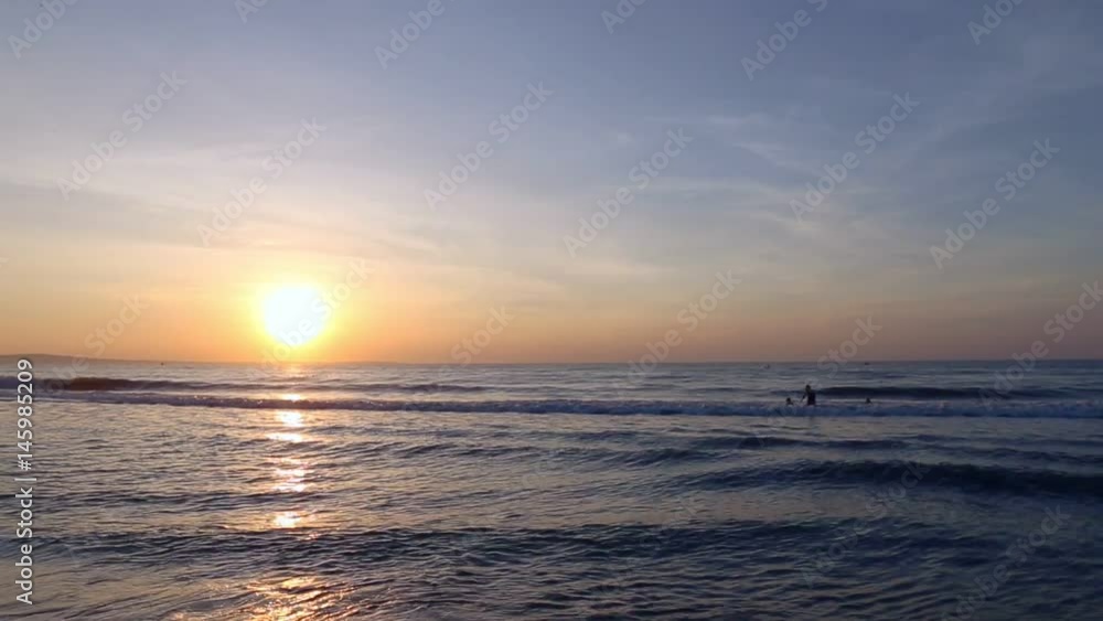 Swimmers in sea sunrise panning left. Swimmers in sea sunrise panning left.