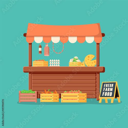 Traditional wooden market food stall full of groceries products with flags, crates and chalk board.