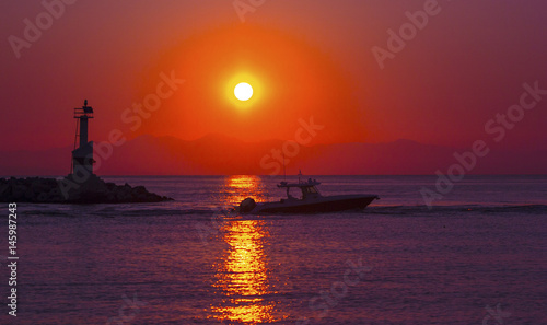 Rental boat and lighthouse in the sunrise shining, Zakynthos, Greece © EgoR