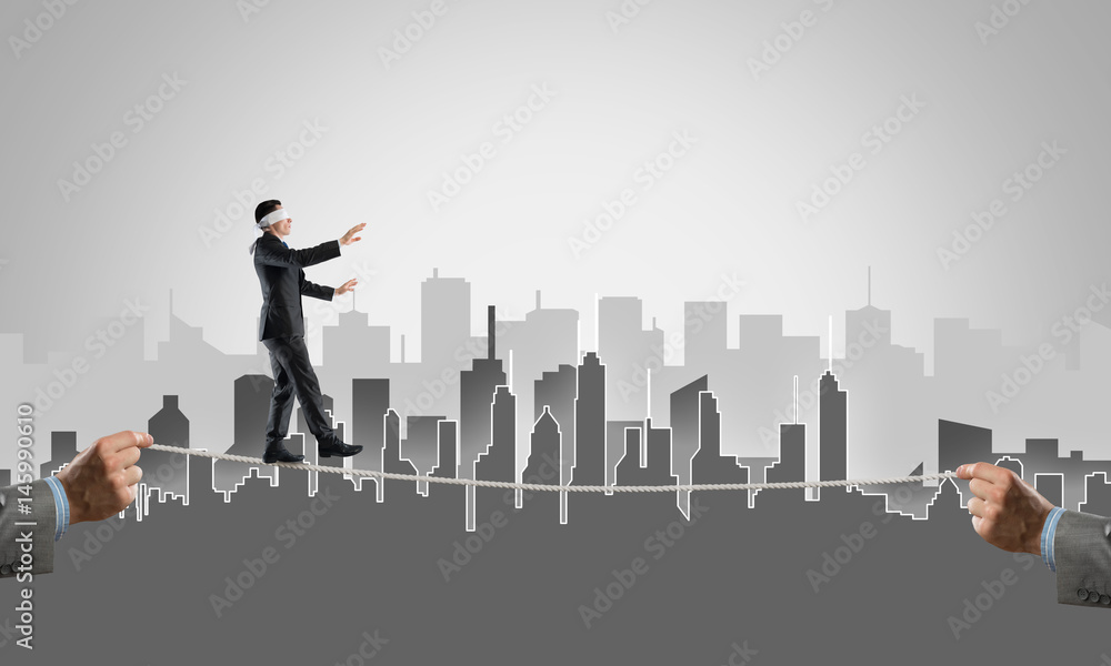 Business concept of risk support and assistance with man balancing on rope Business concept of risk support and assistance with man balancing on rope