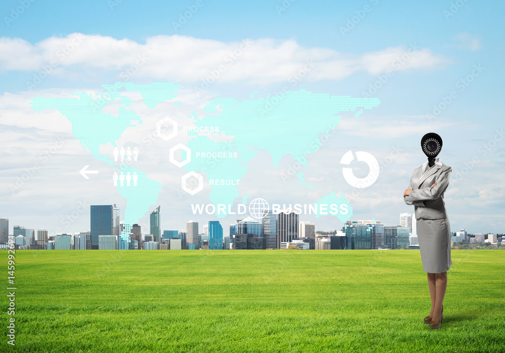 Camera headed woman standing on green grass against modern cityscape Camera headed woman standing on green grass against modern cityscape