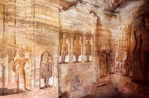 Indian rock-cut architecture. Carved wall dedicated to revered figures of Jainism inside the 7th century cave temple  in town Badami  India